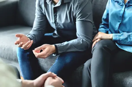 Couple having a conversation on couch